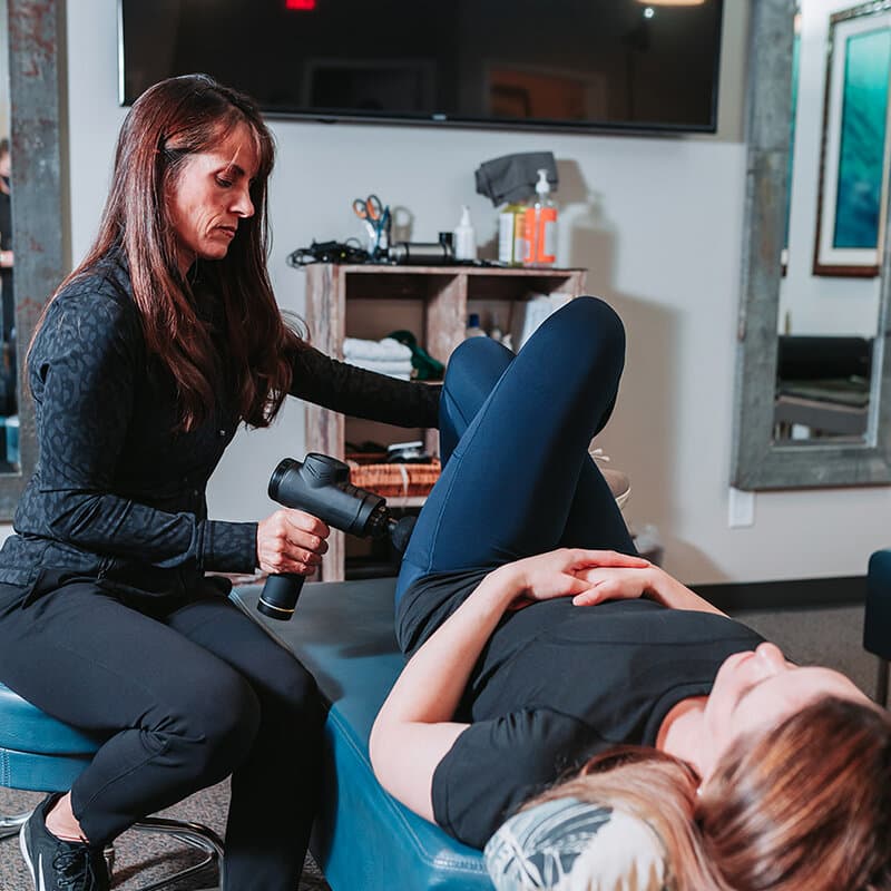 Staff setting up a patient on the AccuSpina spinal decompression table