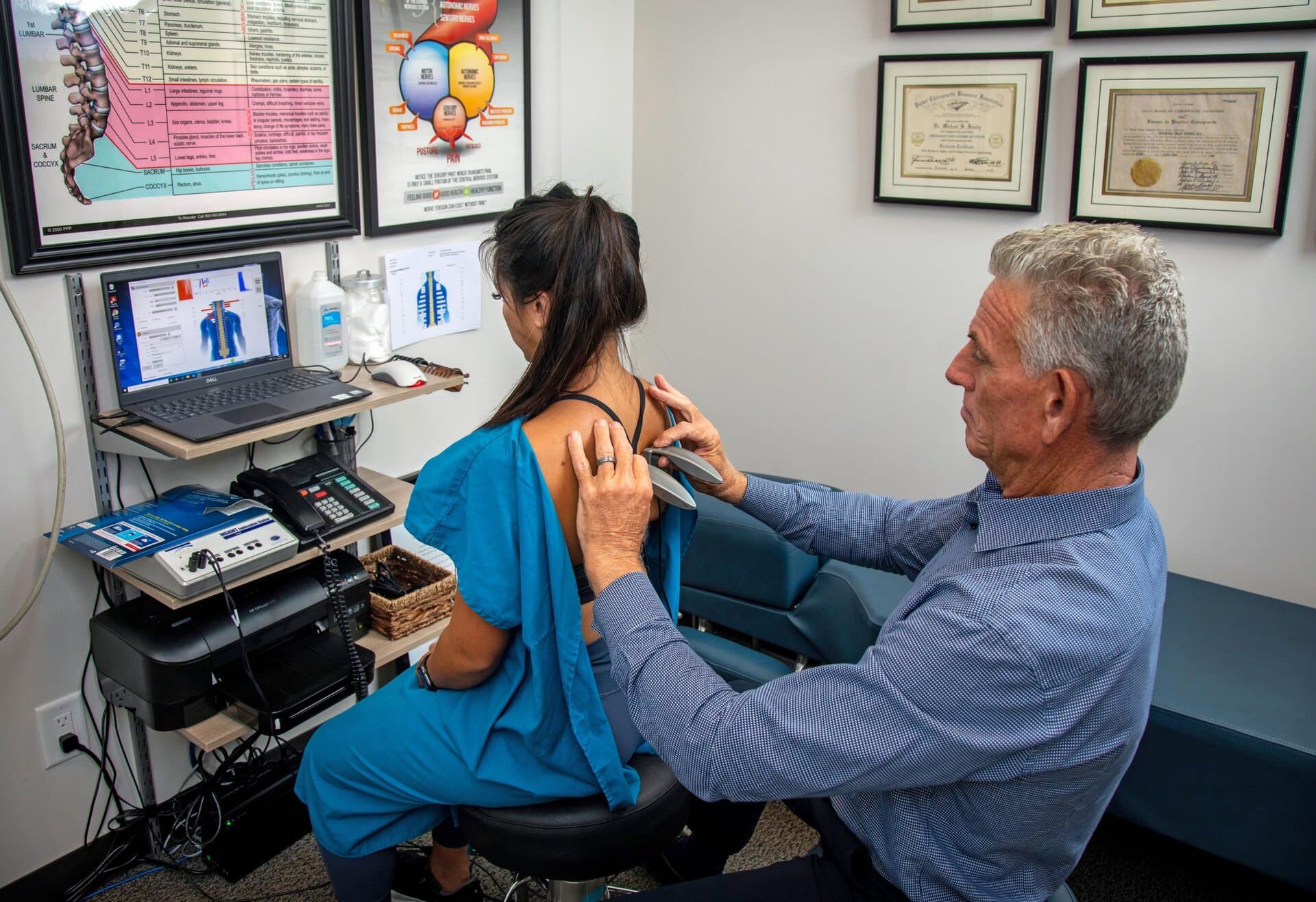 Dr. Foudy reviewing a computerized nervous system scan with a patient, like an EKG of the nervous system