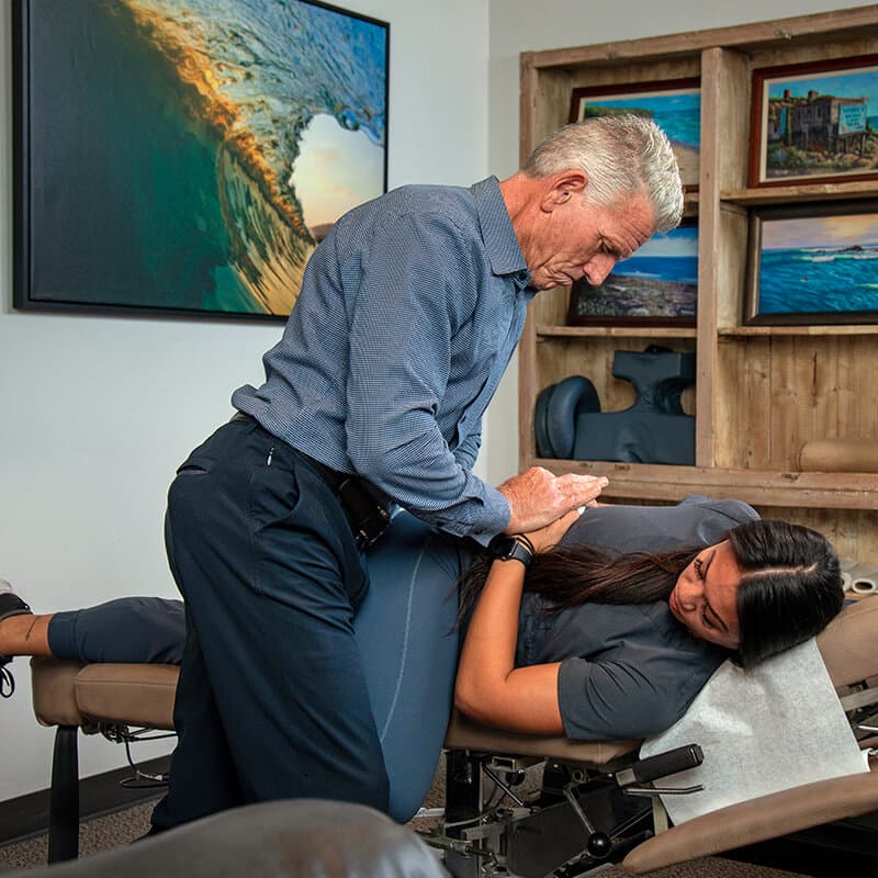 Dr. Foudy performing a side-posture lumbar adjustment
