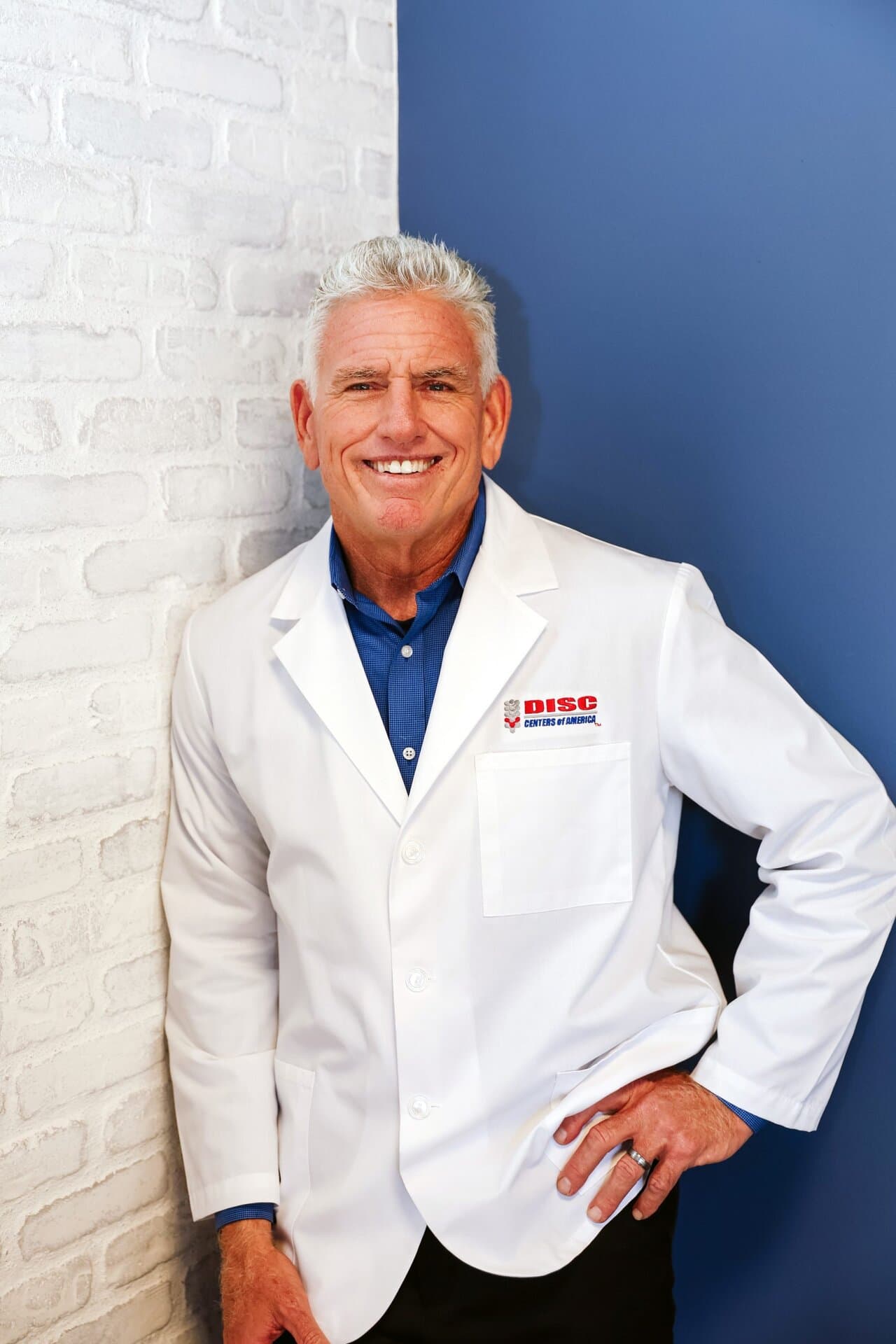 Dr. Michael Foudy standing in his white coat at Foudy Chiropractic in Mission Viejo