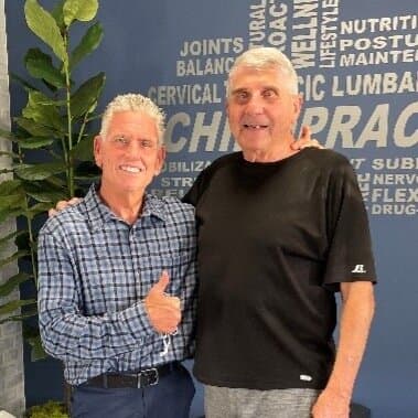 A patient and Dr. Foudy celebrating progress at Foudy Chiropractic