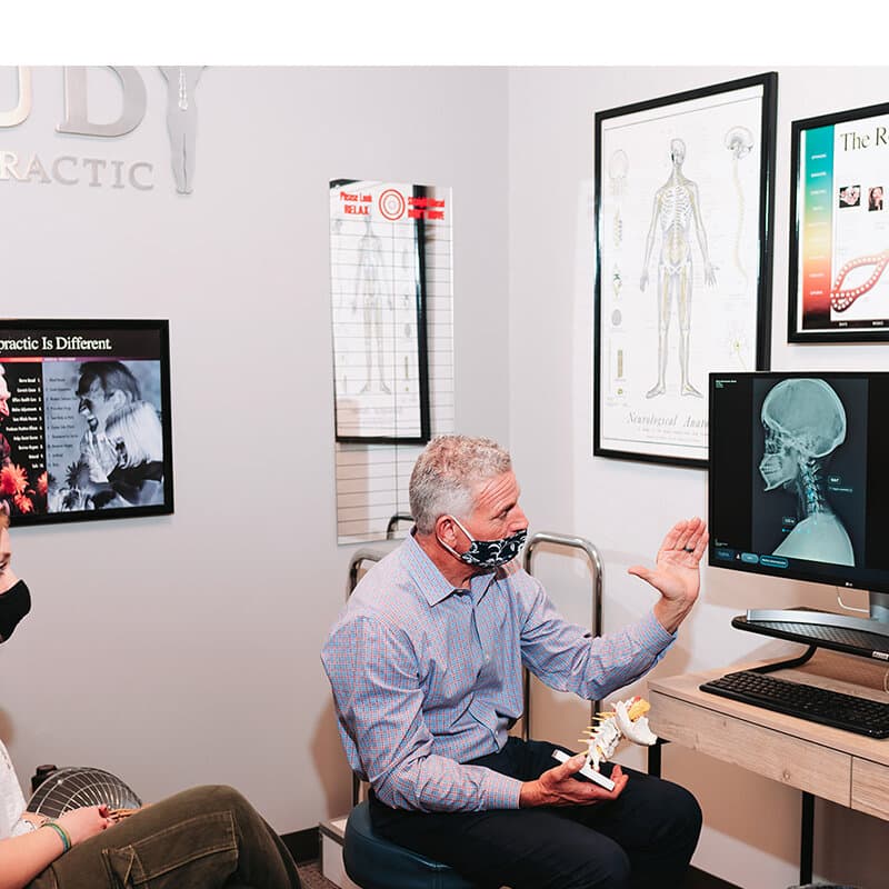 Dr. Foudy explaining X-ray findings to a patient during a report of findings consultation